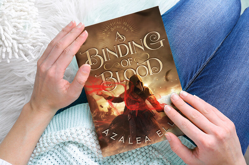 Person holding a Paperback of A Binding of Blood