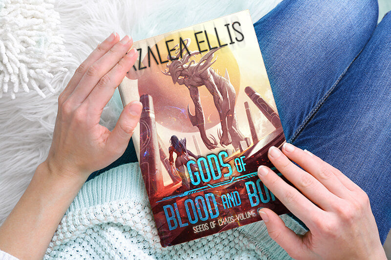 Person holding a Paperback of Gods of Blood and Bone